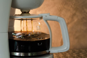 photograph-of-a-dripping-half-full-white-coffee-pot-on-brown-background-m.png