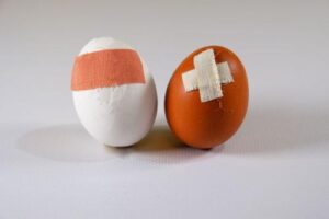 two-damaged-eggs-patched-up-with-plasters-m.jpg