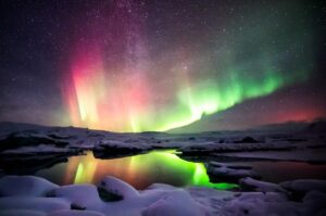 red-and-green-aurora-in-a-starry-sky-above-icy-waters-m.jpg