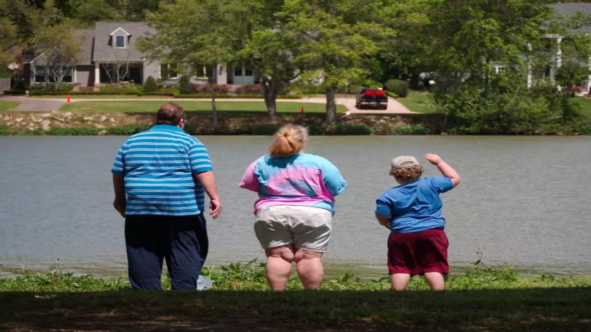 overweight-family-standing-lake-1.jpg