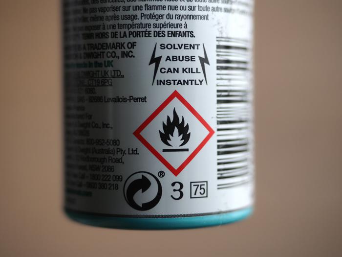 solvent abuse warning label on the back of a can of dry shampoo; the text reads  solvent abuse can kill instantly 