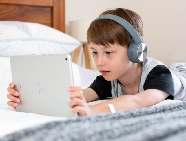 child looking at an ipad